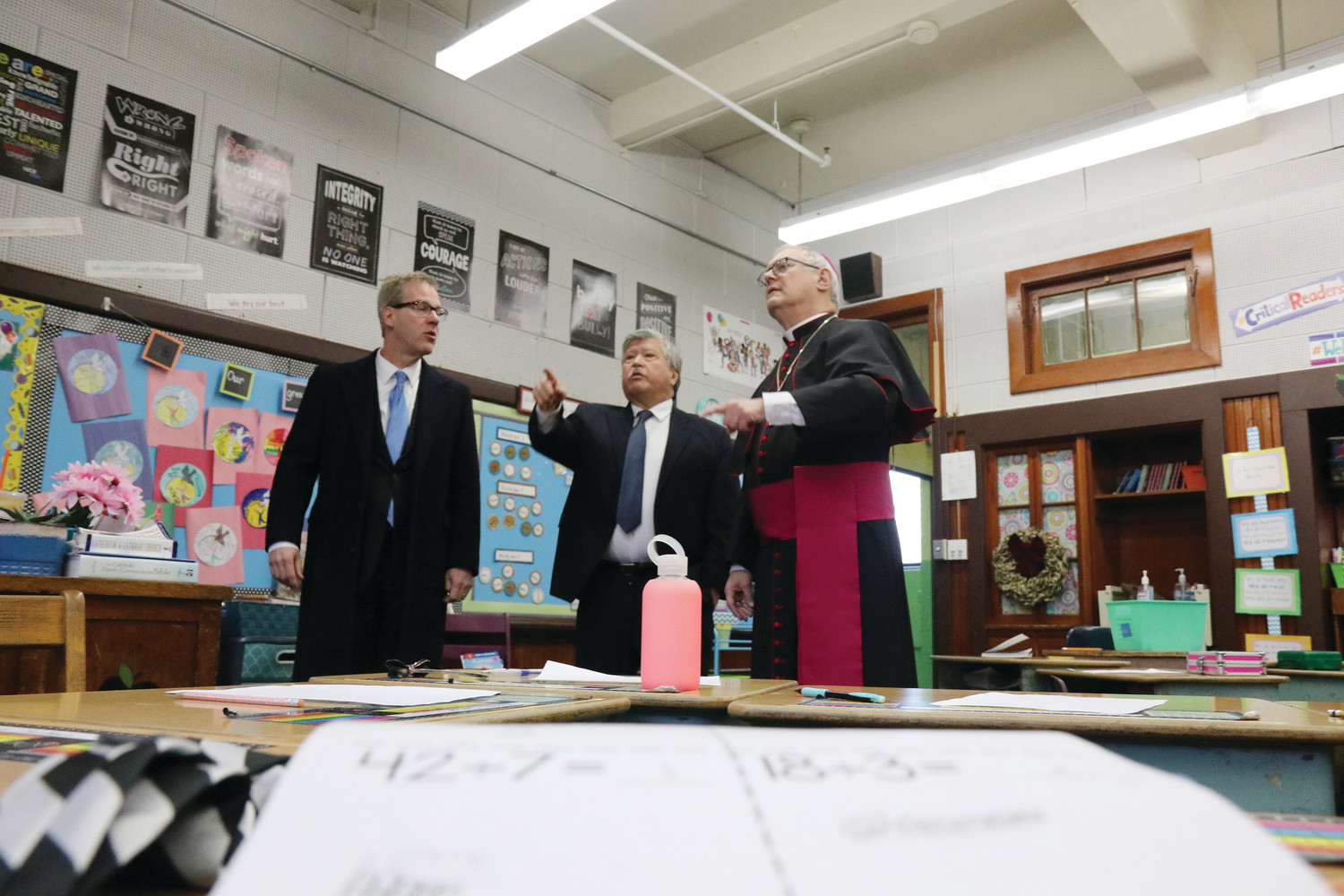 The bishop joins Catholic Schools Superintendent Daniel Ferris and Principal Louis Hebert in touring the school on Wednesday, Dec. 12.